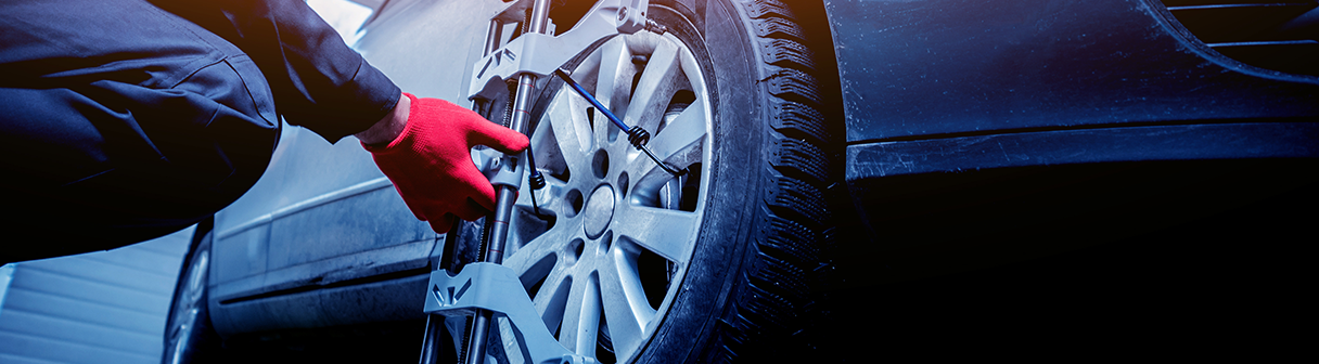Mechanic Inspecting Car Alignment